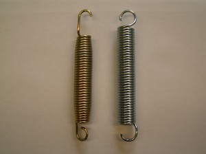 The left hand spring has an elongated hook end for attaching to a round hole in the frame.  The right hand spring is for a frame with a slot hole